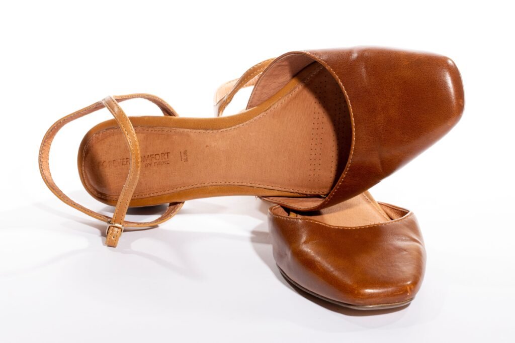 Stylish cognac brown leather flats with comfortable straps. Perfect for casual and formal wear.